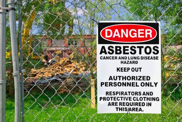 Asbestos warning on fence